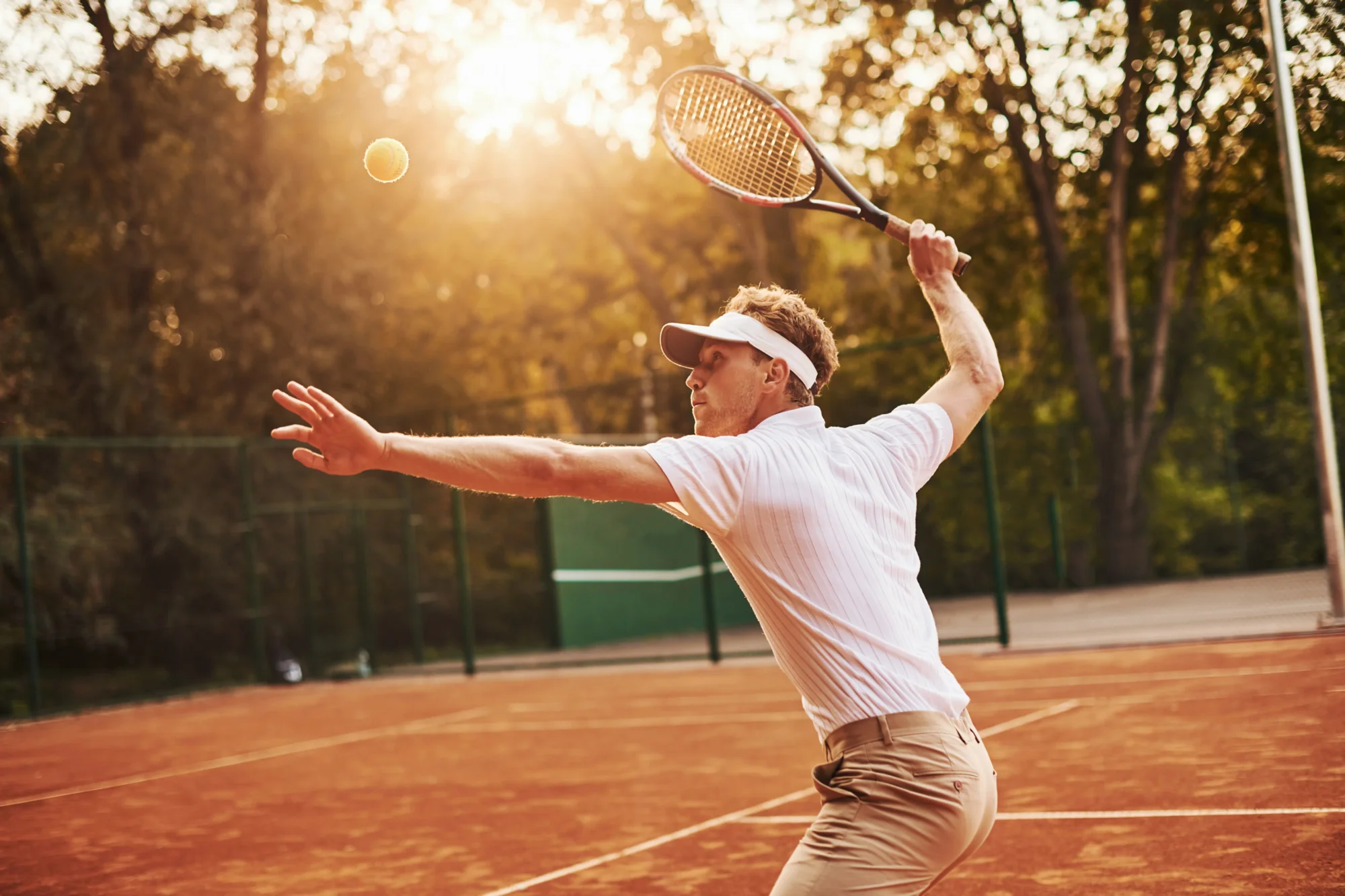 Tennis player mid-serve